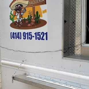 a taqueria truck parked on the side of the road