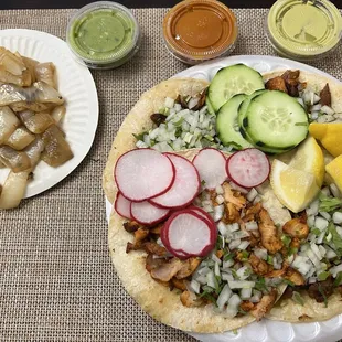 Tacos de Al Pastor y Pollo con todo and cebollas asadas. Three featured salsas.