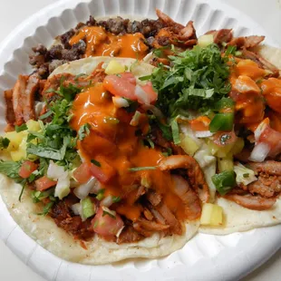 Tacos -- two pastor, one asada -- with salsa, cilantro, and pico de gallo