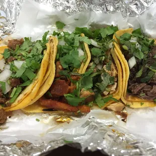 Amazing, authentic street tacos. $1 per taco! Left to right: suadero, pastor, pollo, barbacoa