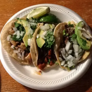 Three types of tacos (L to R): carnitas, al pastor, carne asada