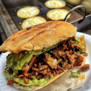 a sandwich on a paper plate