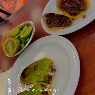 Beef tacos with guacamole and hot spicy red colored salsa / Plain beef tacos/ cucumbers with lemon