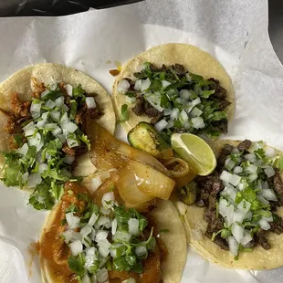 three tacoss on a white paper