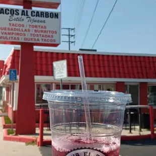 a hand holding a drink