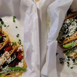 two tacos in white paper