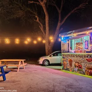 a taqueria truck parked at night