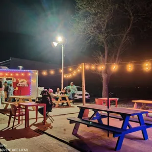 a group of people standing around a food truck