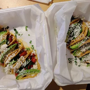 two tacoss with cheese and vegetables