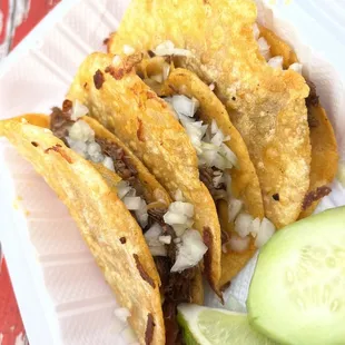 a plate of tacos and a cucumber