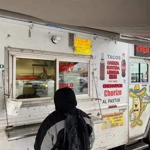 a person standing in front of a food truck