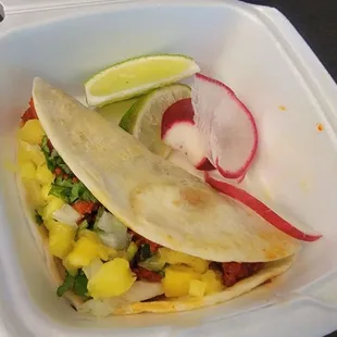 Tiny al pastor taco on flour tortilla