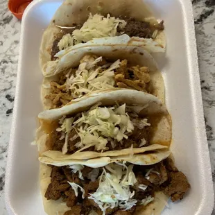 Top to bottom: cabeza taco, pollo taco, birria taco, and adobada taco.