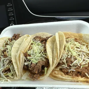three tacos in a styrofoam container