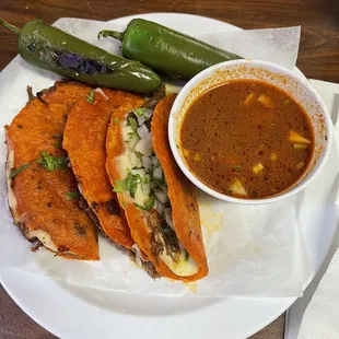 Quesobirria Tacos, 3, with consumé. Doesn&apos;t come with jalapenos. I added them.