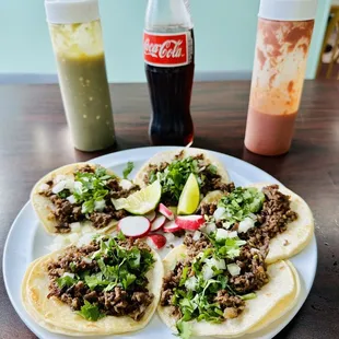 a plate of tacos and a coke