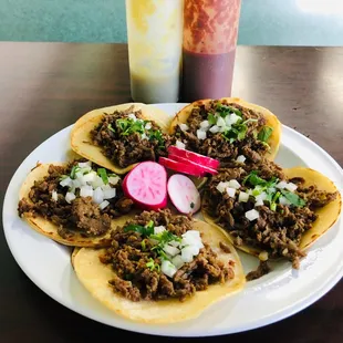 a plate of tacos and a drink