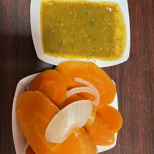 a bowl of soup and a bowl of sliced oranges