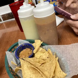 Complimentary chips and bean dip (very mild) , and the house sauces (very hot)