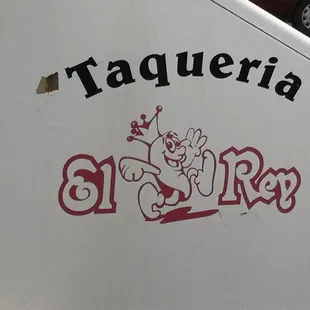 a taqueria sign on the side of a food truck