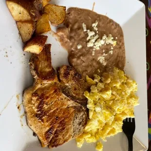 "Leo's Breakfast", overcooked dry eggs, cold beans, and a way overcooked pork chop. Try eating it with their cheap plastic fork.......