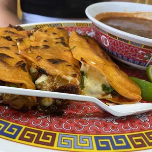 Birria tacos Beef tacos with cheese Beef consumé with cilantro and lime