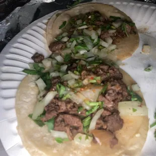 two tacos on a paper plate