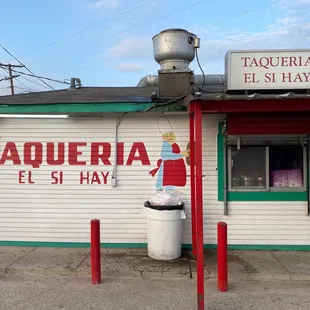 a man standing in front of a restaurant