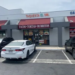 two cars parked in front of the store