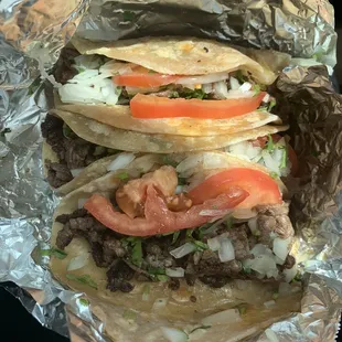 Beef fajita tacos on flour tortillas with tomato