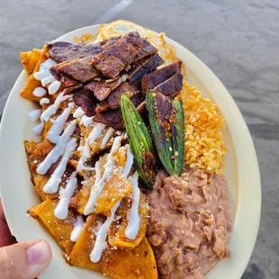 Chulaquiles! With some Carne Asada  followed by rice &amp; beans.