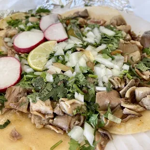 a taco with mushrooms and radishes