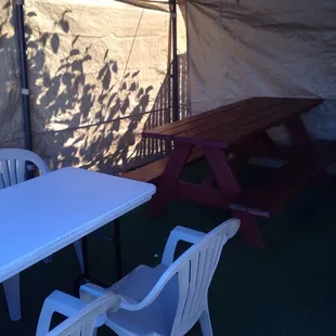 a table and chairs under a tent
