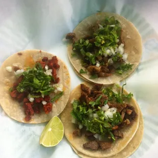 three tacos on a paper plate