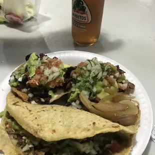 two tacos on a paper plate