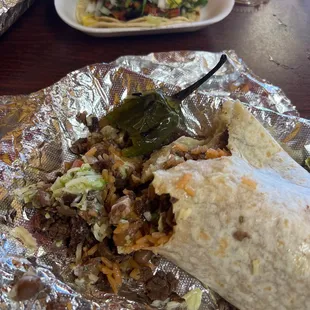 A súper burrito and an adobada taco
