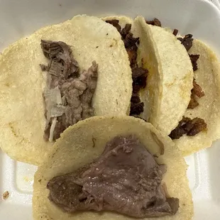 three tacos in a styrofoam container