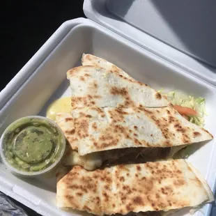 two quesadillas in a styrofoam container