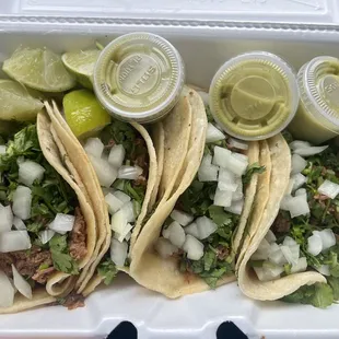 Barbacoa Tacos with cilantro and onion with avocado salsa