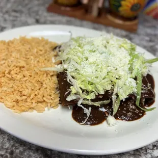 Chicken enmoladas with lettuce, cheese and side of rice