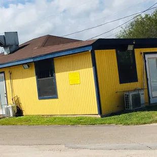 a yellow building with a blue trim
