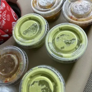 a variety of condiments in plastic containers