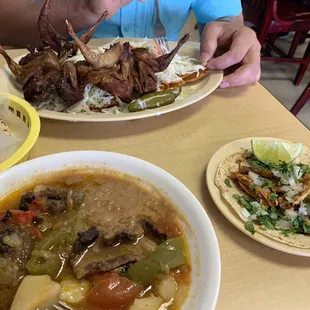 Papas con bistec on the bottom left, taco de pollo on the right and enchiladas con huilotas on the top