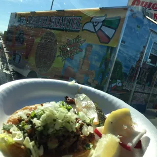 a plate of food in front of a food truck