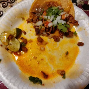 a paper plate with a taco on it
