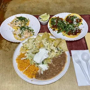 Tacos chicken and chorizo and green chilaquiles with rice and beans