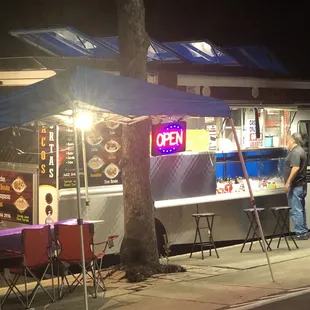 Parked on the street next to the liquor store.