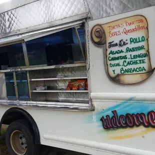 a taqueria truck parked in a field