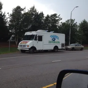 a taqueria truck parked on the side of the road