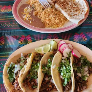 two plates of tacos and rice